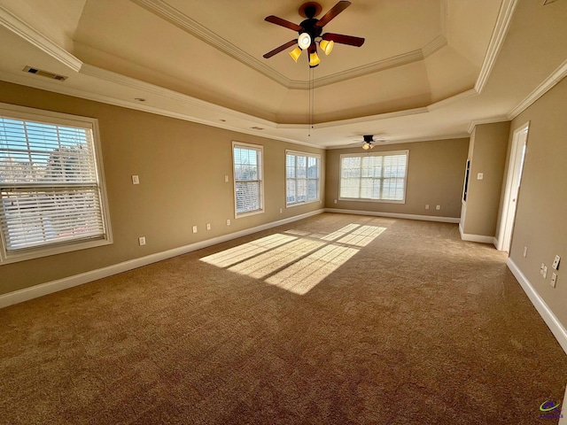 spare room with crown molding, carpet, ceiling fan, and a tray ceiling