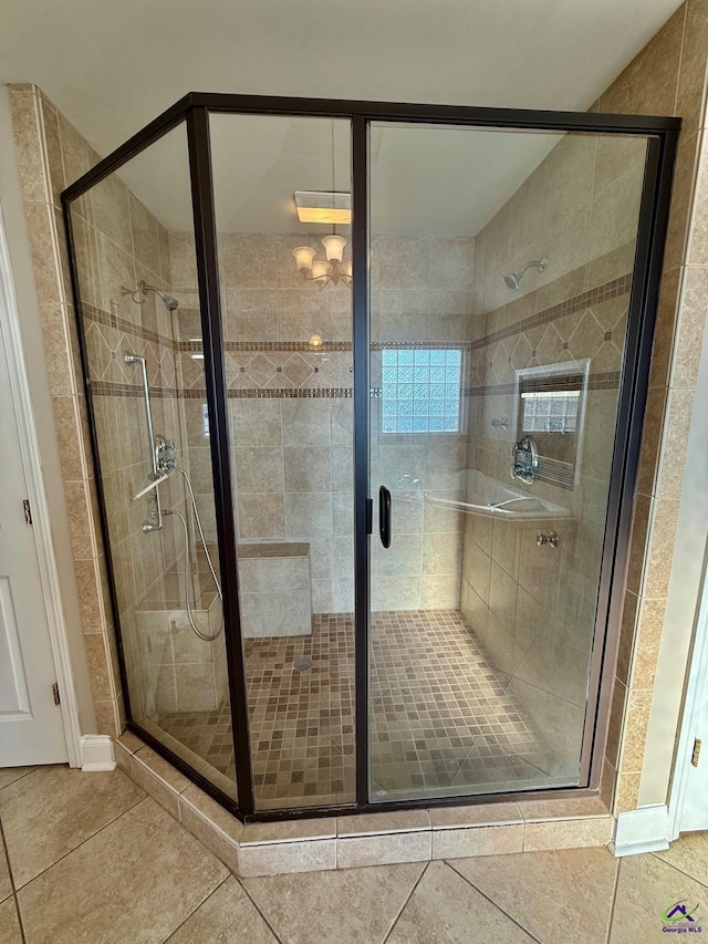 bathroom featuring tile patterned floors and a shower with shower door