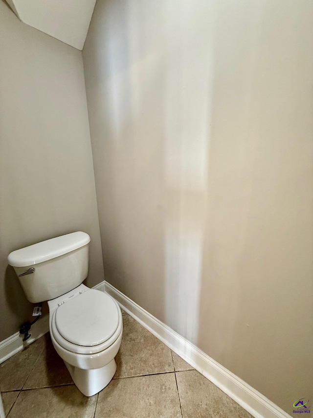 bathroom featuring toilet and tile patterned flooring