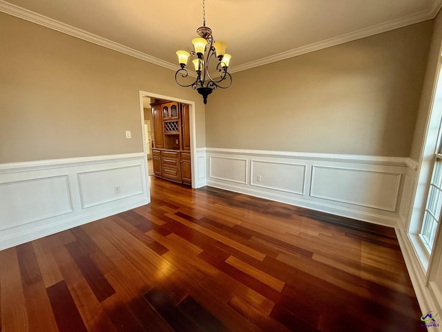 unfurnished dining area with ornamental molding, a notable chandelier, and dark hardwood / wood-style flooring