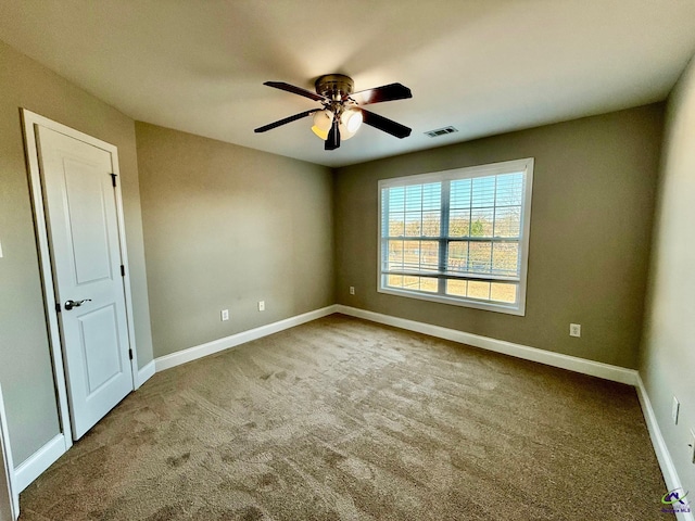 carpeted empty room with ceiling fan