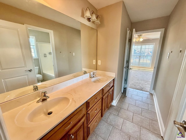 bathroom featuring vanity, tile patterned flooring, a bathing tub, and toilet