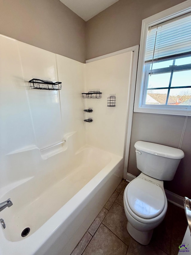 bathroom with toilet, tile patterned flooring, and shower / bathing tub combination