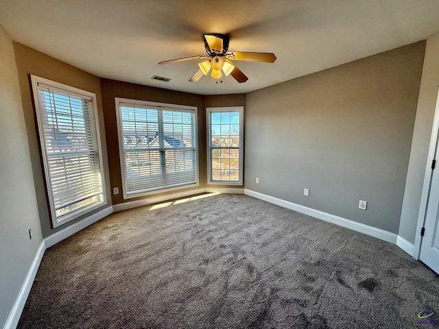 empty room featuring ceiling fan and carpet flooring