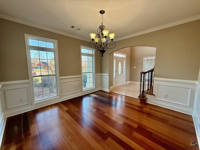 interior space with crown molding, a notable chandelier, and light hardwood / wood-style flooring