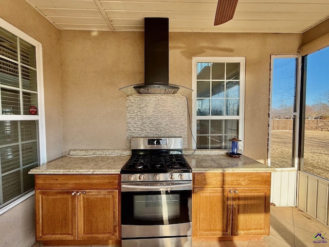 kitchen featuring stainless steel range with gas stovetop and wall chimney exhaust hood