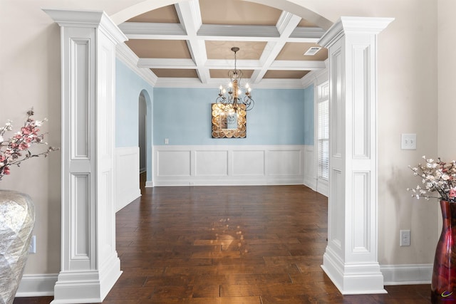 unfurnished dining area with decorative columns, coffered ceiling, dark hardwood / wood-style flooring, and beam ceiling