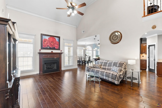 living room with crown molding, ceiling fan, dark hardwood / wood-style flooring, and high vaulted ceiling