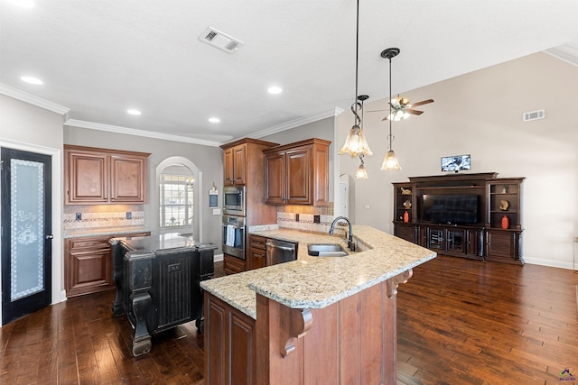 kitchen with appliances with stainless steel finishes, sink, a kitchen breakfast bar, kitchen peninsula, and light stone countertops