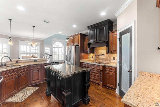 kitchen with a kitchen island, sink, dark hardwood / wood-style flooring, stainless steel appliances, and crown molding