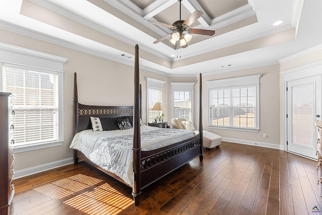 bedroom featuring coffered ceiling, ornamental molding, dark wood-type flooring, and a tray ceiling