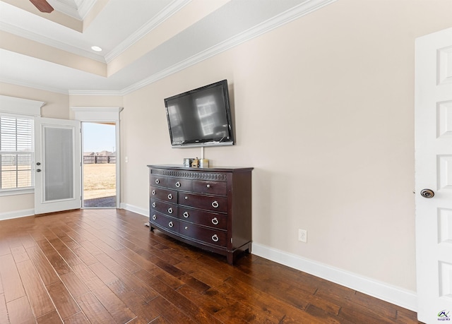 unfurnished bedroom with a raised ceiling, crown molding, and dark hardwood / wood-style flooring