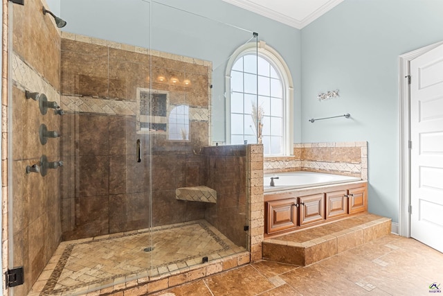 bathroom featuring crown molding and separate shower and tub