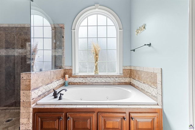 bathroom featuring separate shower and tub and a wealth of natural light