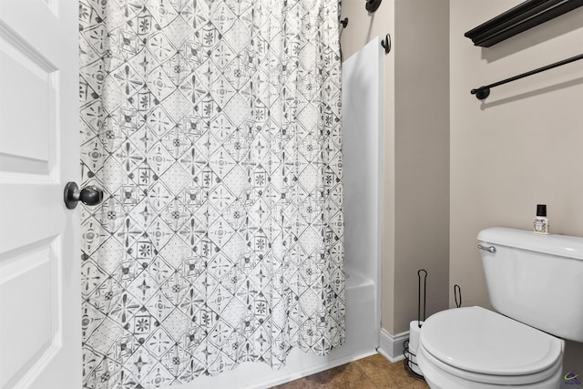 bathroom featuring shower / tub combo with curtain, tile patterned floors, and toilet