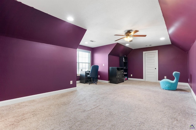 interior space with vaulted ceiling, ceiling fan, and carpet flooring