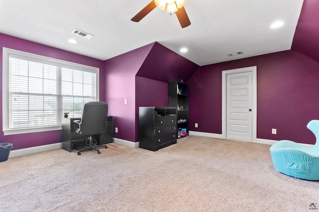 home office with ceiling fan, lofted ceiling, carpet flooring, and a textured ceiling