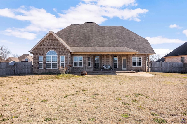 rear view of house with a patio area and a lawn