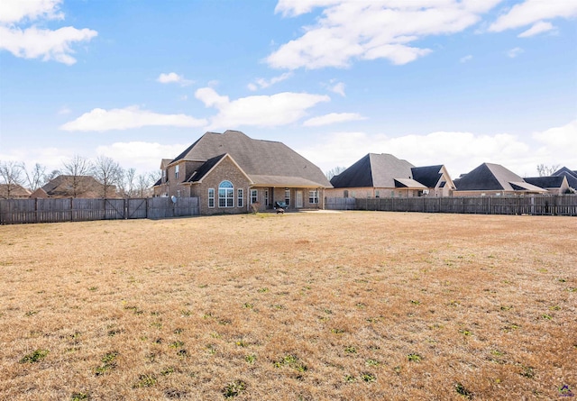 rear view of house featuring a lawn