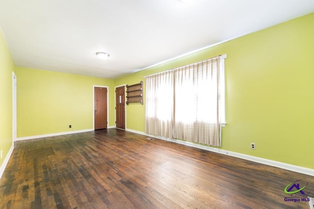 empty room with dark hardwood / wood-style floors