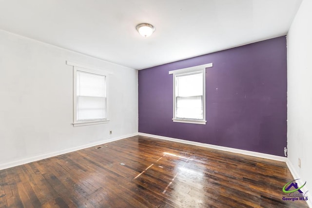 unfurnished room featuring dark hardwood / wood-style floors