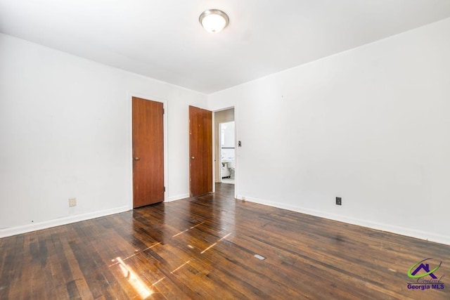 unfurnished room with dark hardwood / wood-style floors