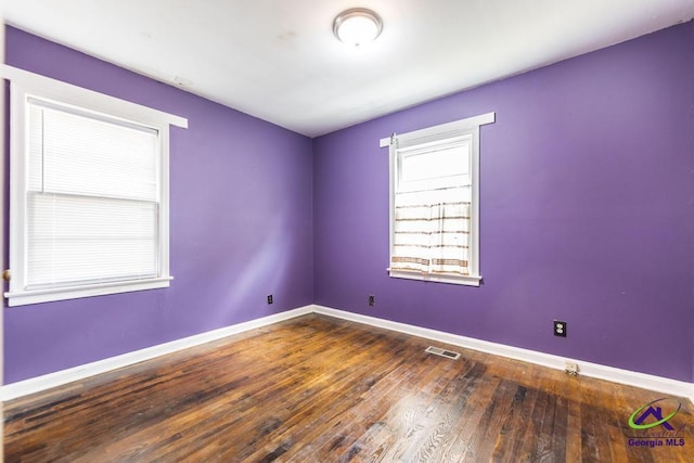 spare room with wood-type flooring