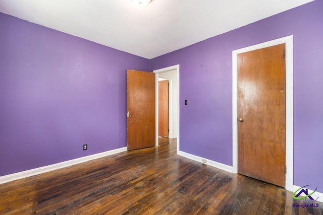 unfurnished bedroom featuring dark hardwood / wood-style floors