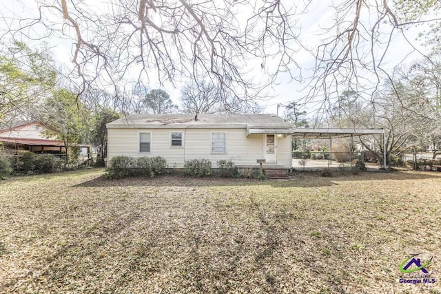 back of property featuring a yard