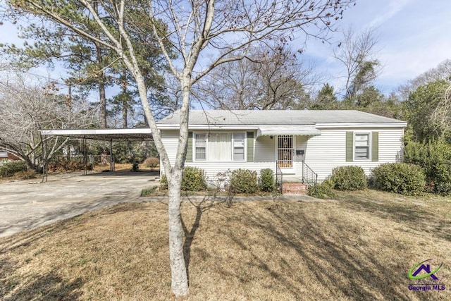 ranch-style house with a carport and a front lawn