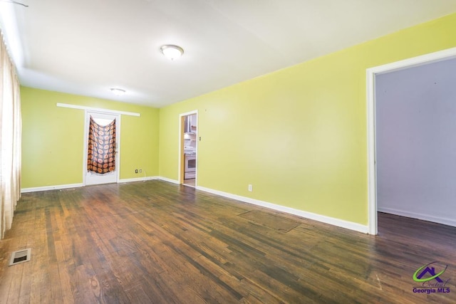 unfurnished room featuring dark hardwood / wood-style floors