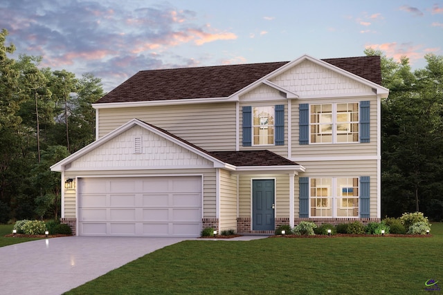 view of front of property with a garage and a yard