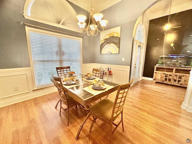 dining room with wood-type flooring and a chandelier