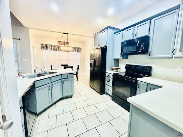 kitchen featuring light tile patterned floors, sink, hanging light fixtures, black appliances, and a chandelier