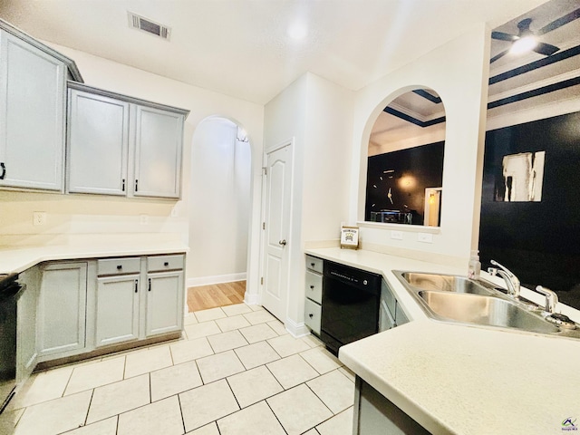 kitchen with sink, light tile patterned floors, dishwasher, gray cabinetry, and stove