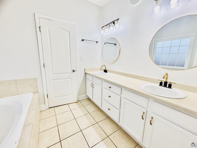 bathroom featuring tile patterned flooring, vanity, and tiled tub