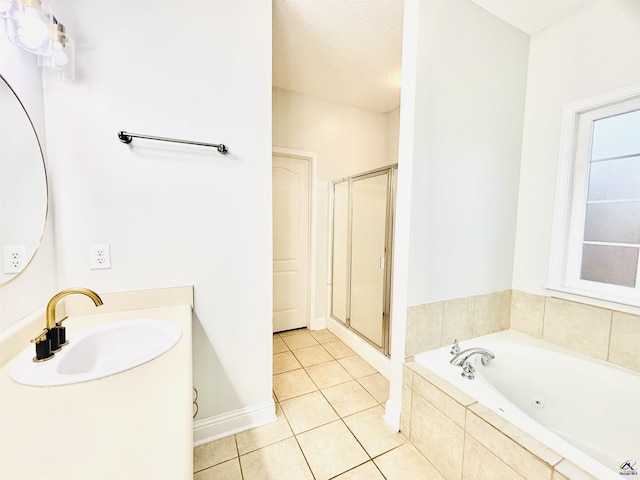 bathroom featuring tile patterned flooring, independent shower and bath, and sink