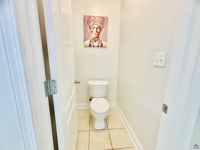 bathroom with tile patterned flooring and toilet