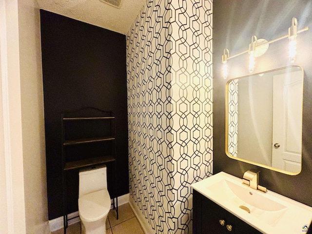 bathroom featuring vanity, toilet, and tile patterned flooring