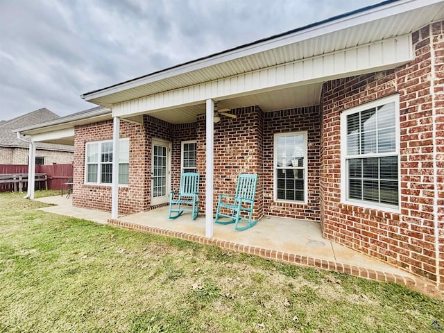 back of house with a patio and a yard