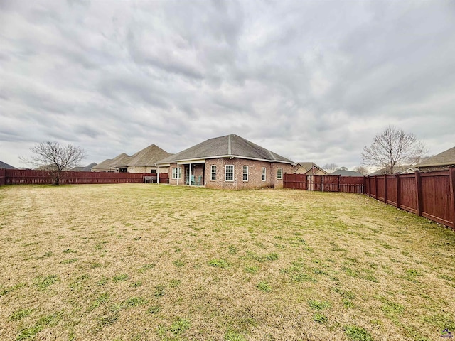 back of house featuring a yard