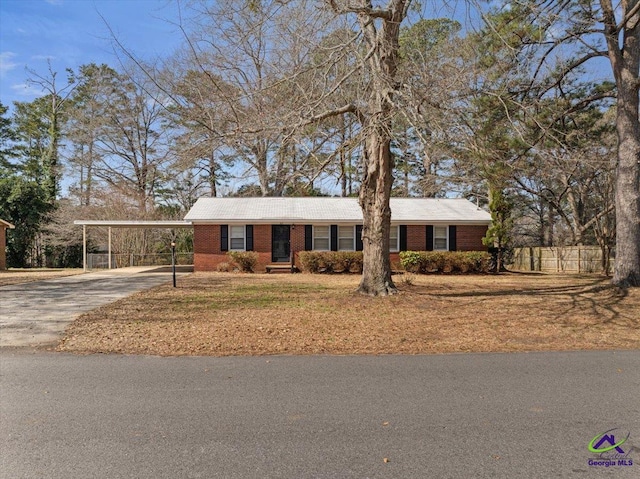 ranch-style house featuring a carport