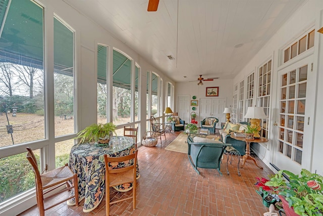 sunroom featuring ceiling fan, wood ceiling, a healthy amount of sunlight, and baseboard heating