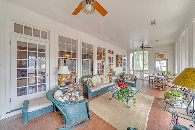 sunroom / solarium featuring ceiling fan