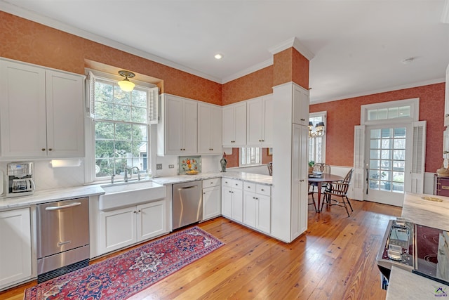 kitchen with white cabinetry, stainless steel dishwasher, and sink