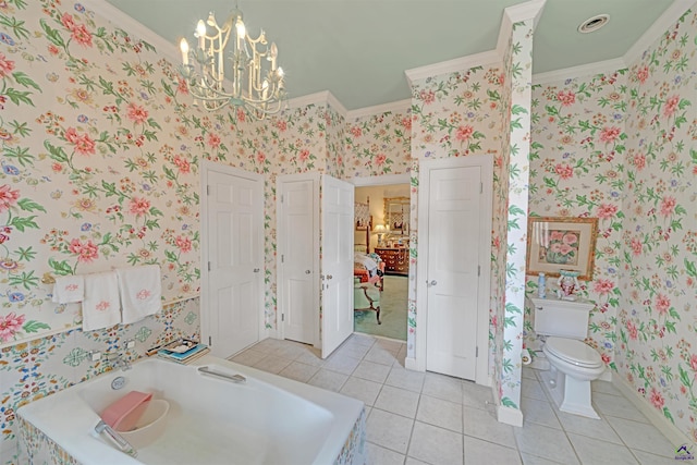 bathroom with tile patterned floors, toilet, ornamental molding, a bathtub, and a notable chandelier