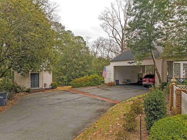 view of vehicle parking with a garage