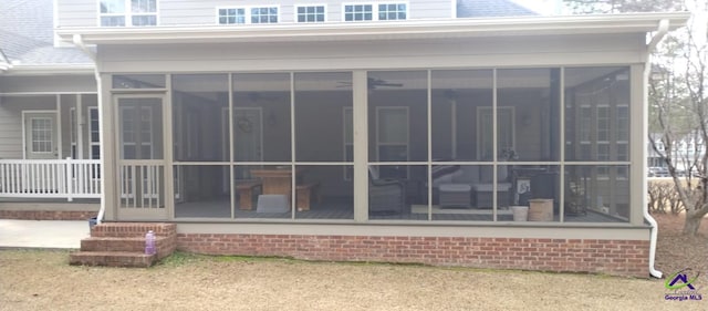 rear view of house with a sunroom