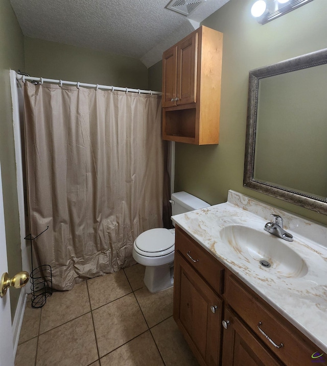 bathroom featuring vanity, tile patterned floors, toilet, and a textured ceiling