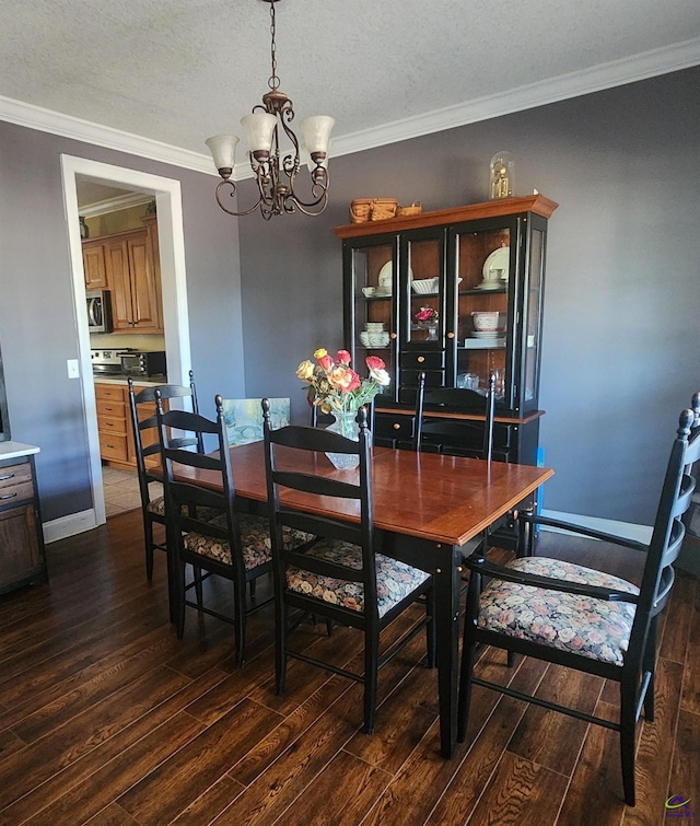 dining room featuring an inviting chandelier, crown molding, dark wood-type flooring, and a textured ceiling